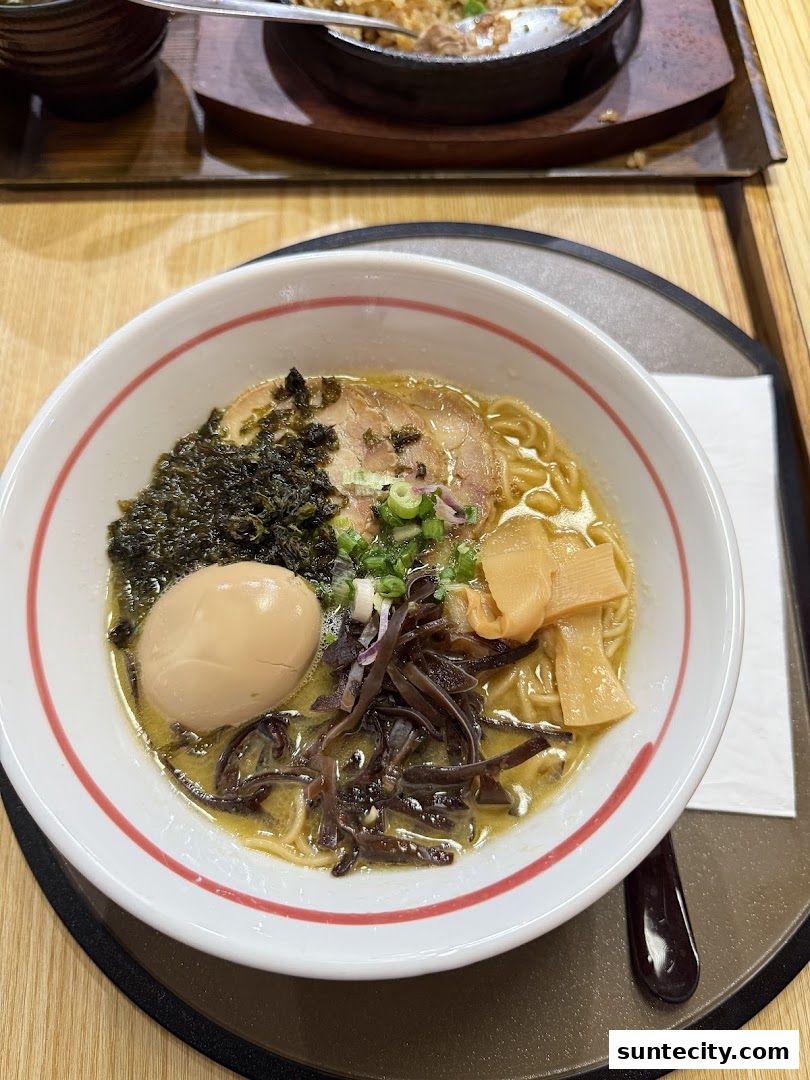 A close-up of a delicious bowl of ramen with egg, seaweed, and pork.