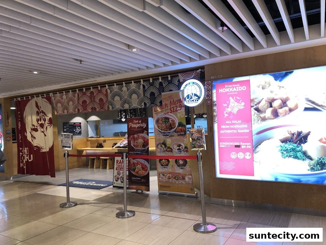 The entrance to Ichikokudo Hokkaido Ramen, featuring promotional posters and traditional Japanese decor.
