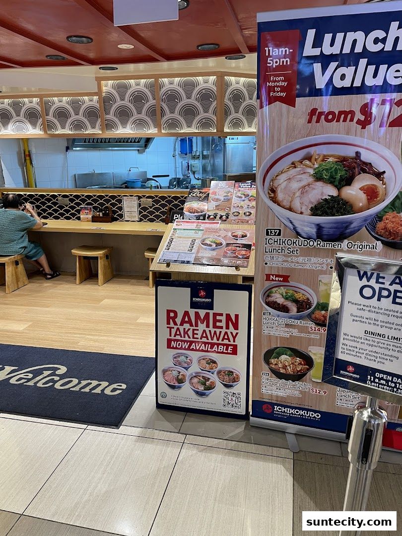 Ichikokudo Hokkaido Ramen shop entrance with a welcome mat and promotional posters.