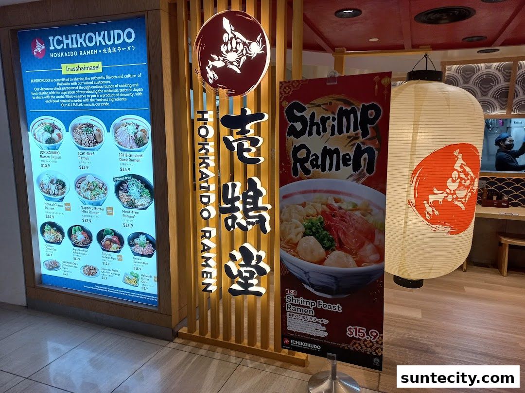 The storefront of Ichikokudo Hokkaido Ramen features a digital menu board and promotional posters.