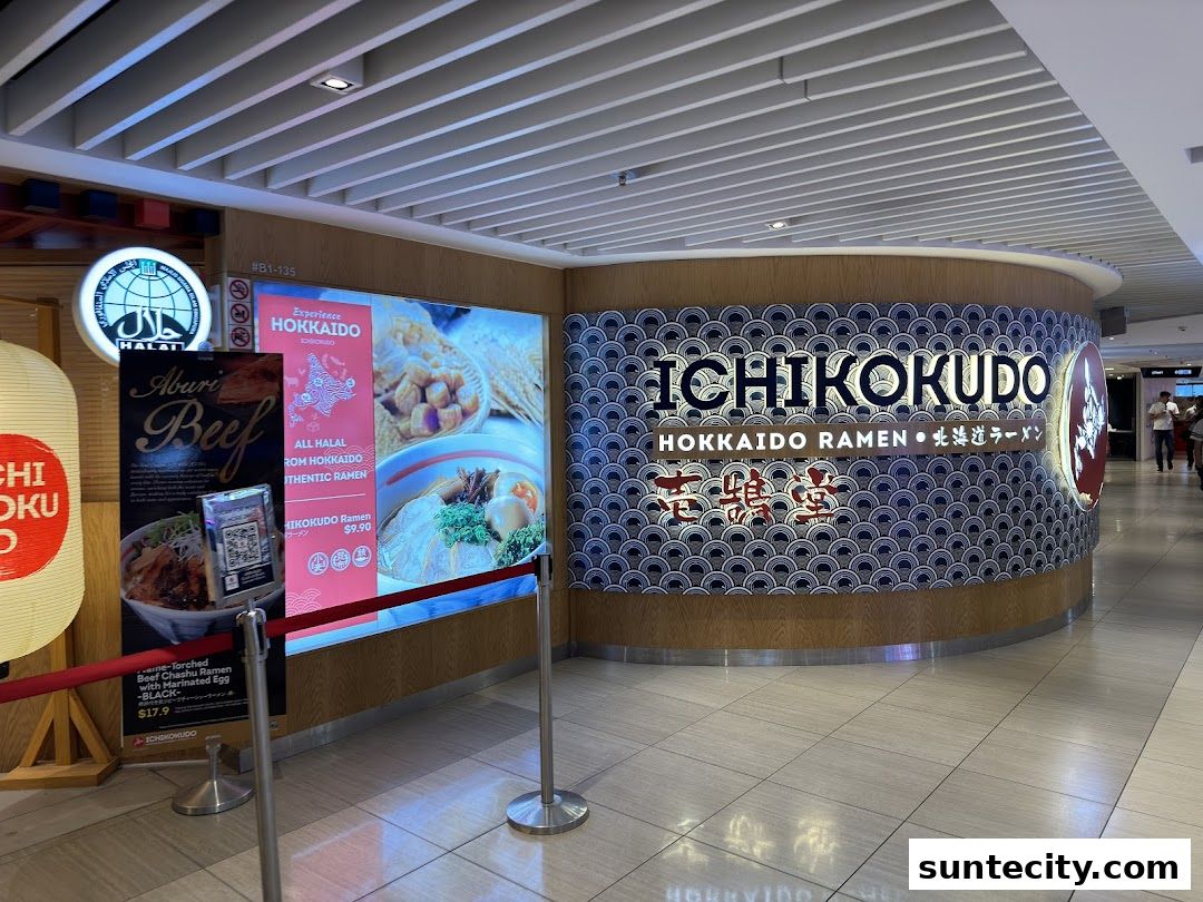 The exterior of Ichikokudo Hokkaido Ramen shop with illuminated signage and menu displays.