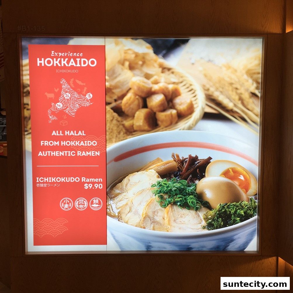 A sign advertising Ichikokudo Hokkaido Ramen, featuring a bowl of ramen and promotional text.