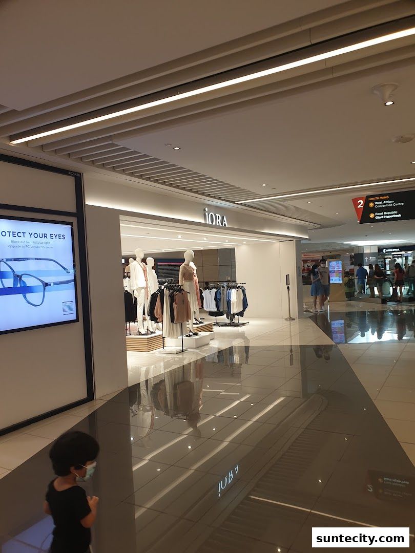 The entrance of the iORA fashion store at Suntec City, showcasing mannequins and clothing.