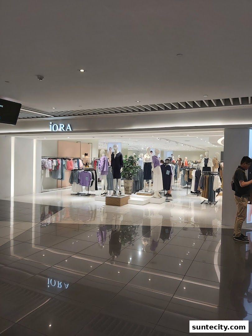 The iORA Suntec City shop front displays a variety of clothing on mannequins and racks.