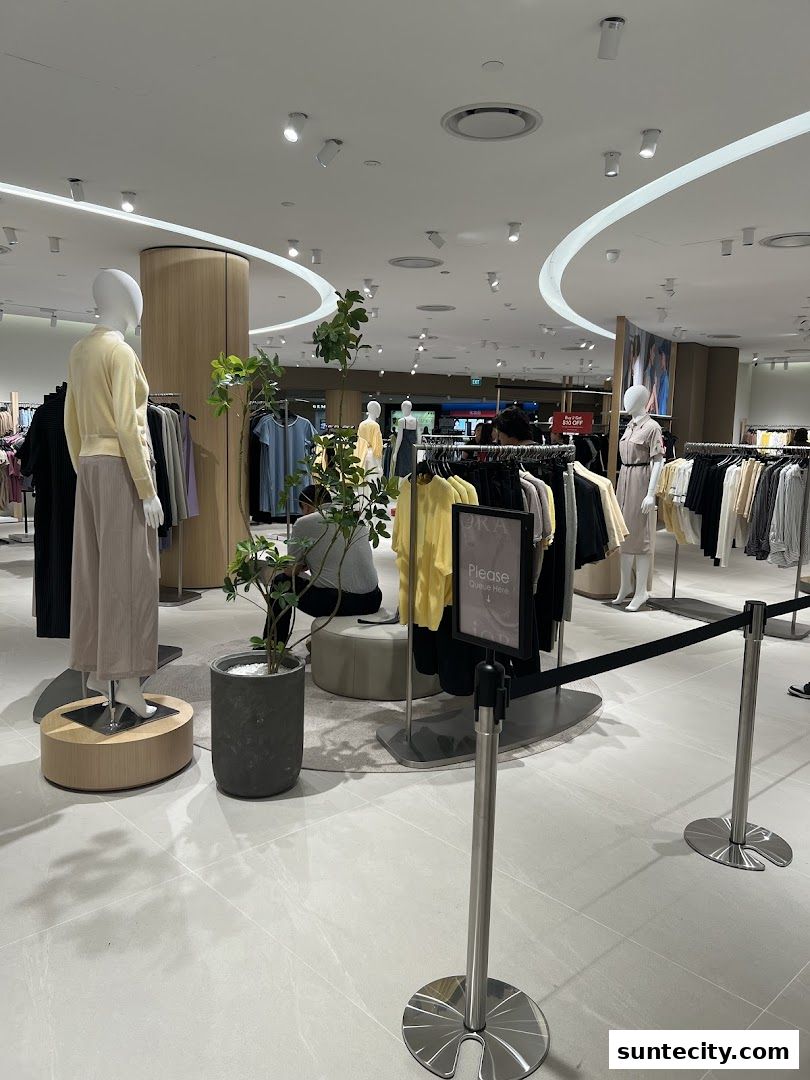 Interior view of a clothing store with mannequins and racks of apparel.
