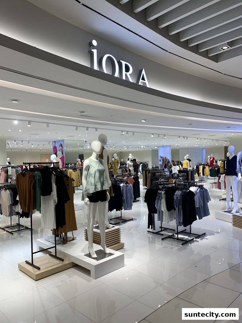 Interior view of the iORA fashion store at Suntec City, showcasing clothing on racks and mannequins.
