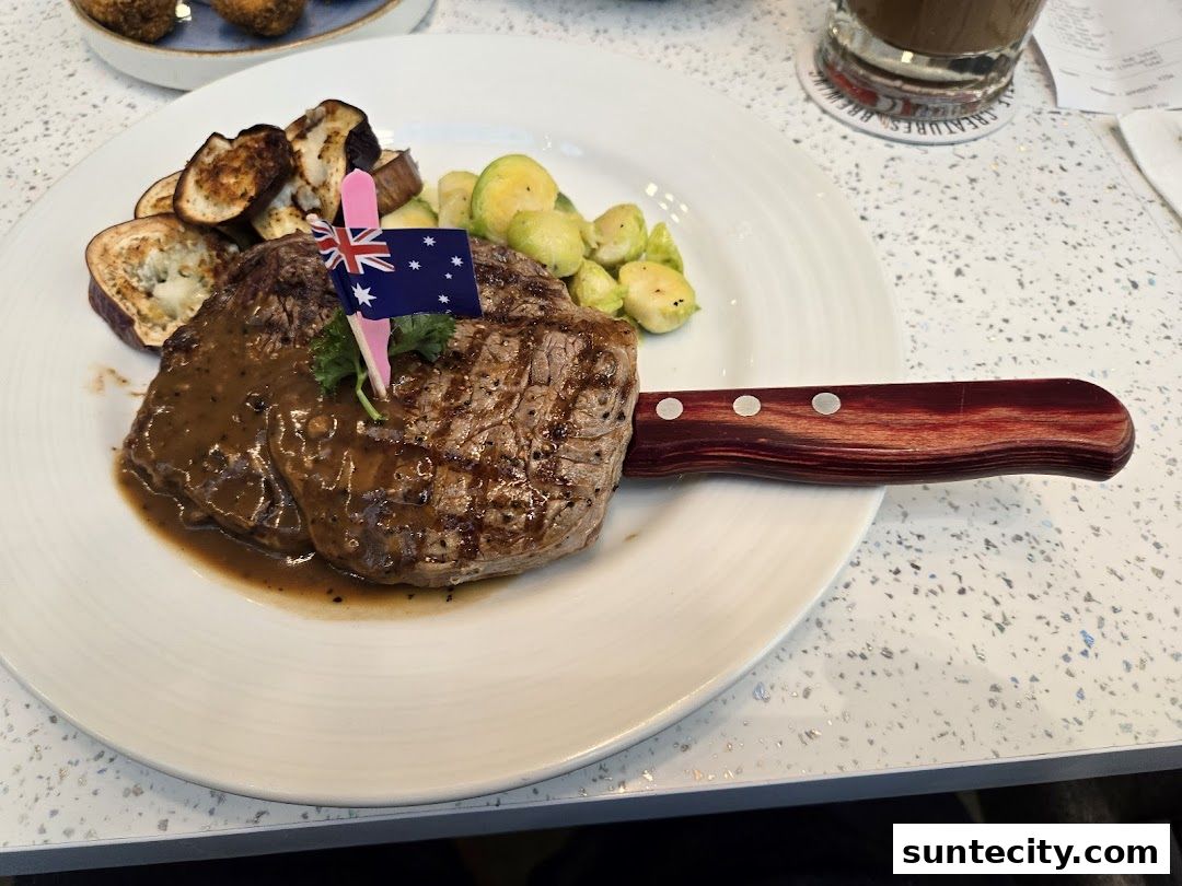 A juicy steak with grilled eggplant and Brussels sprouts, garnished with an Australian flag.