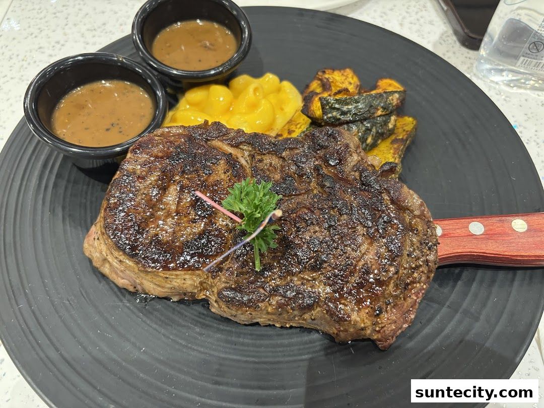A juicy steak served with mashed potatoes, roasted pumpkin, and two dipping sauces.