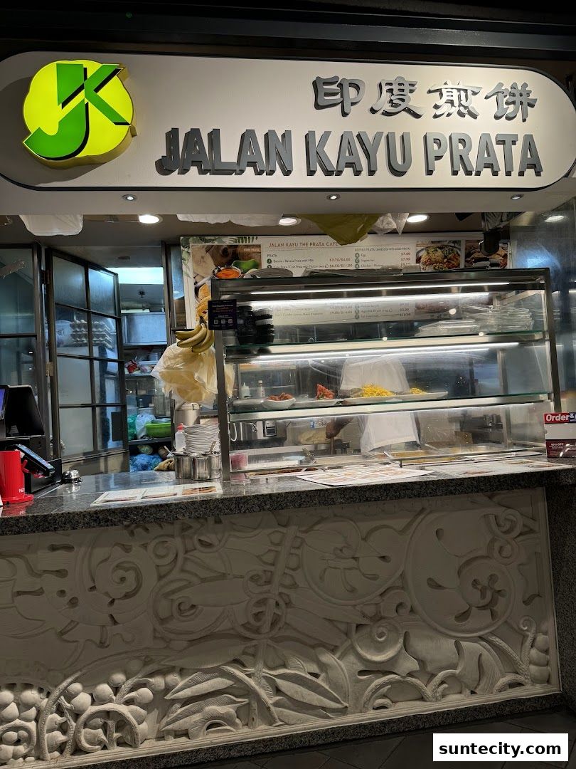 The exterior of Jalan Kayu Prata Cafe with its prominent signage and display counter.