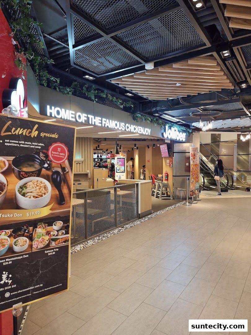 The Jollibee restaurant entrance with a lunch specials menu board in the foreground.