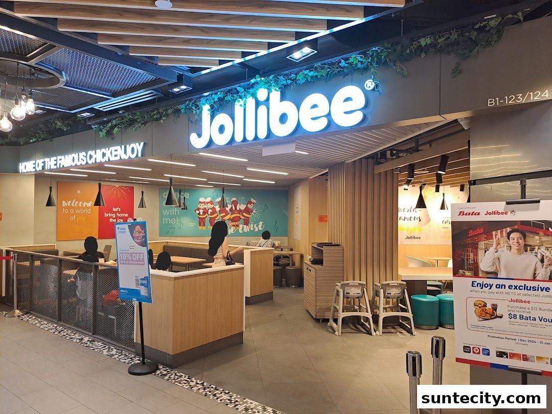 The Jollibee restaurant entrance with its iconic signage and interior seating visible.