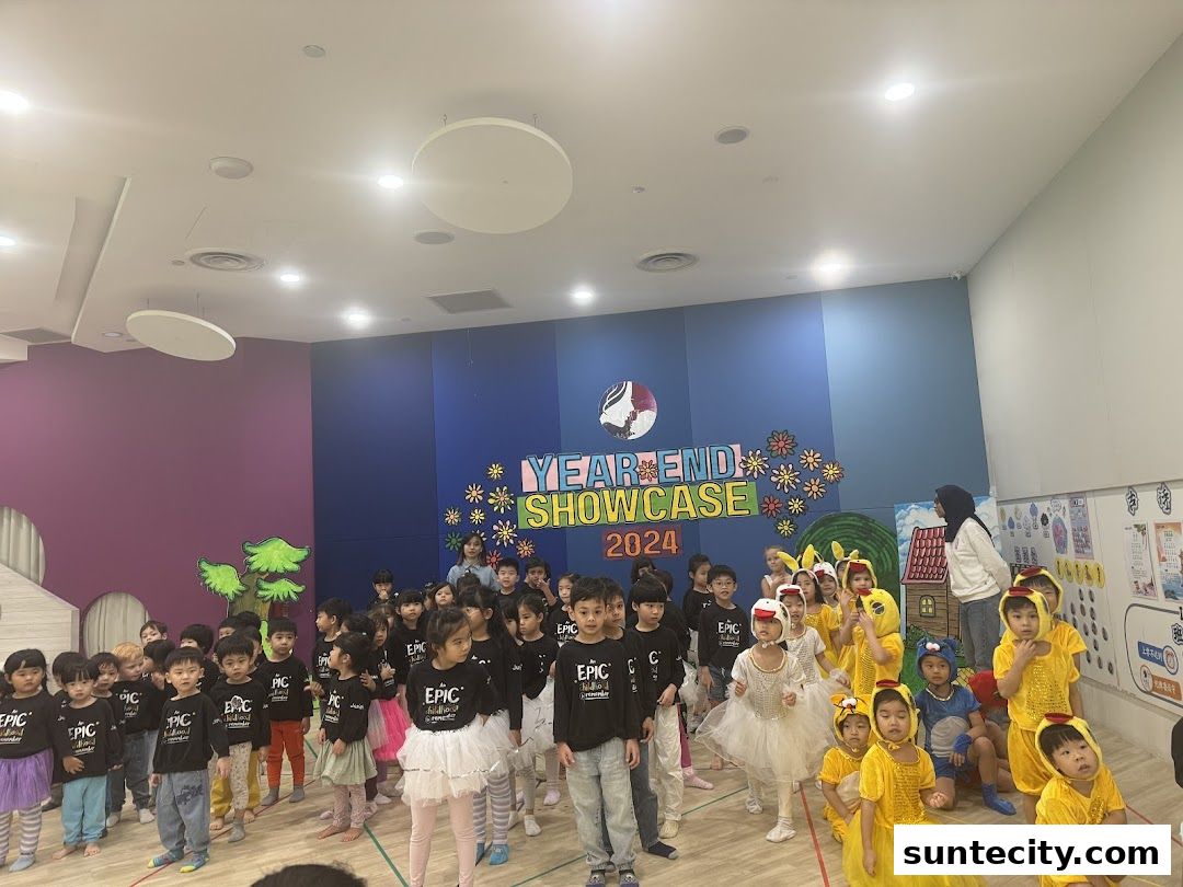 Children in costumes perform at a year-end showcase event.