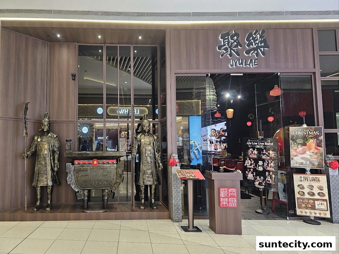 The entrance of Jyu Lae Bistro, featuring traditional statues and festive Christmas decorations.