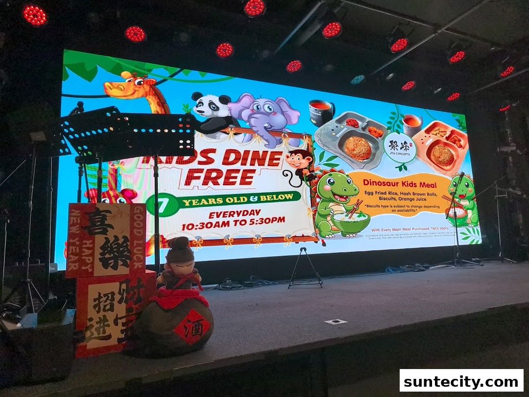 A large screen displays a promotion for Jyu Lae Bistro's "Kids Dine Free" offer and Dinosaur Kids Meal.