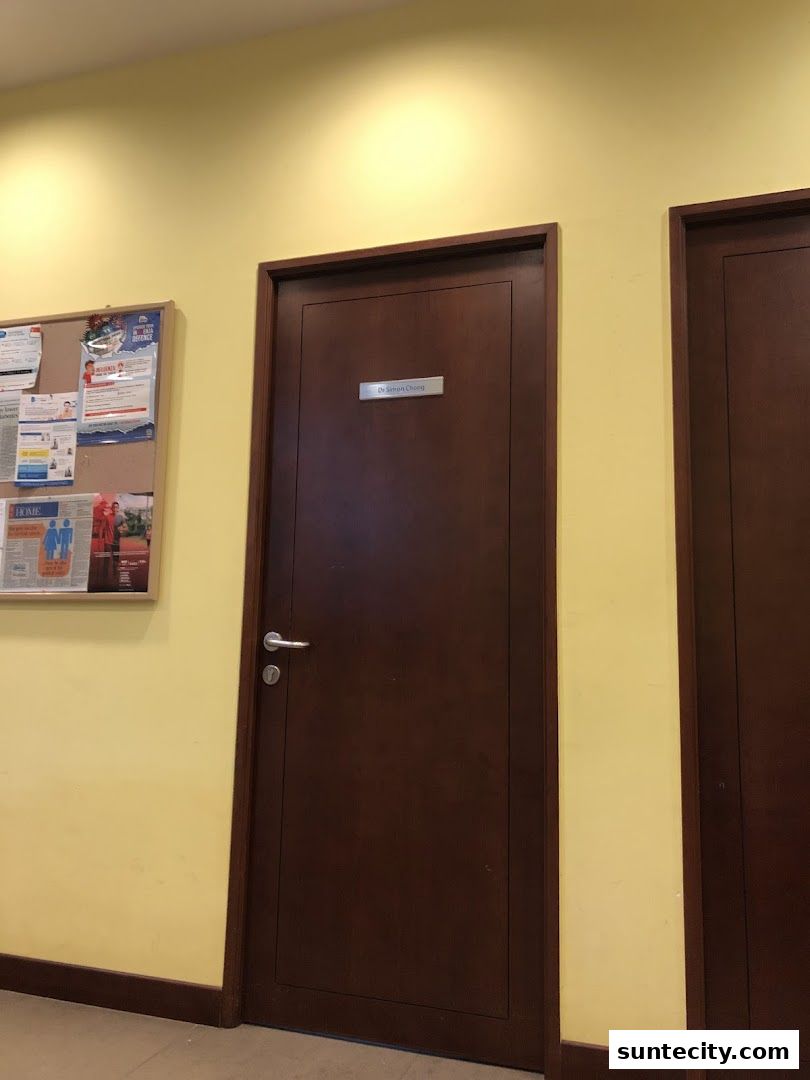 A closed wooden door with a nameplate reading 'Dr Simon Chong'.