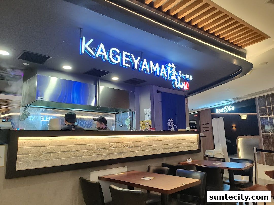 Kageyama restaurant with neon sign and chefs working behind the counter.