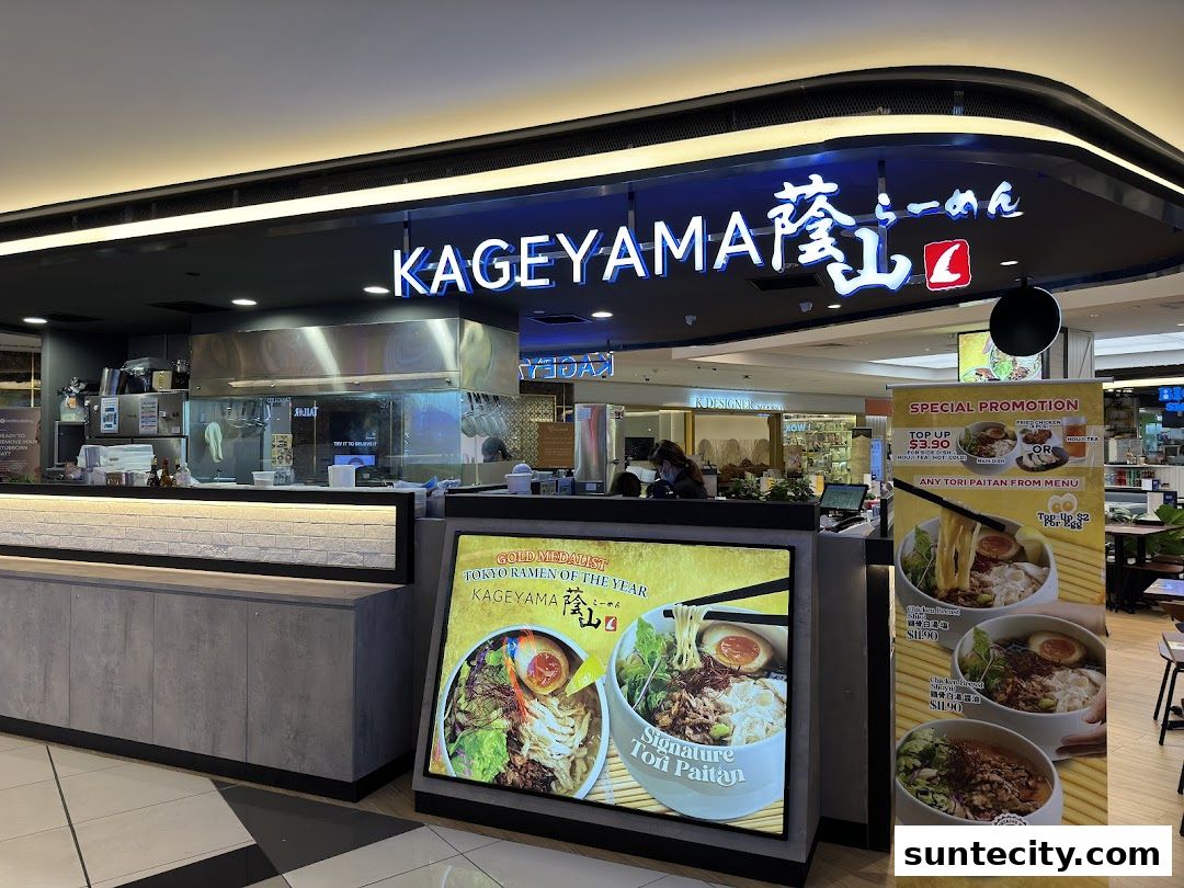 The exterior of Kageyama, a ramen shop, with illuminated signage and promotional displays.