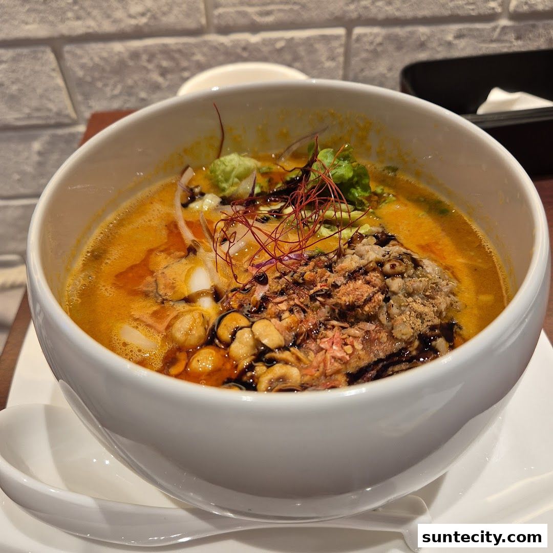 A close-up shot of a steaming bowl of ramen with rich broth and various toppings.