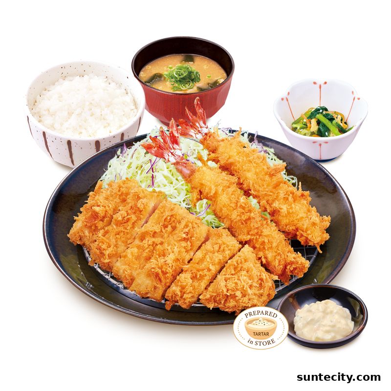 A delicious set meal featuring crispy pork cutlet, fried shrimp, rice, miso soup, and a side dish.