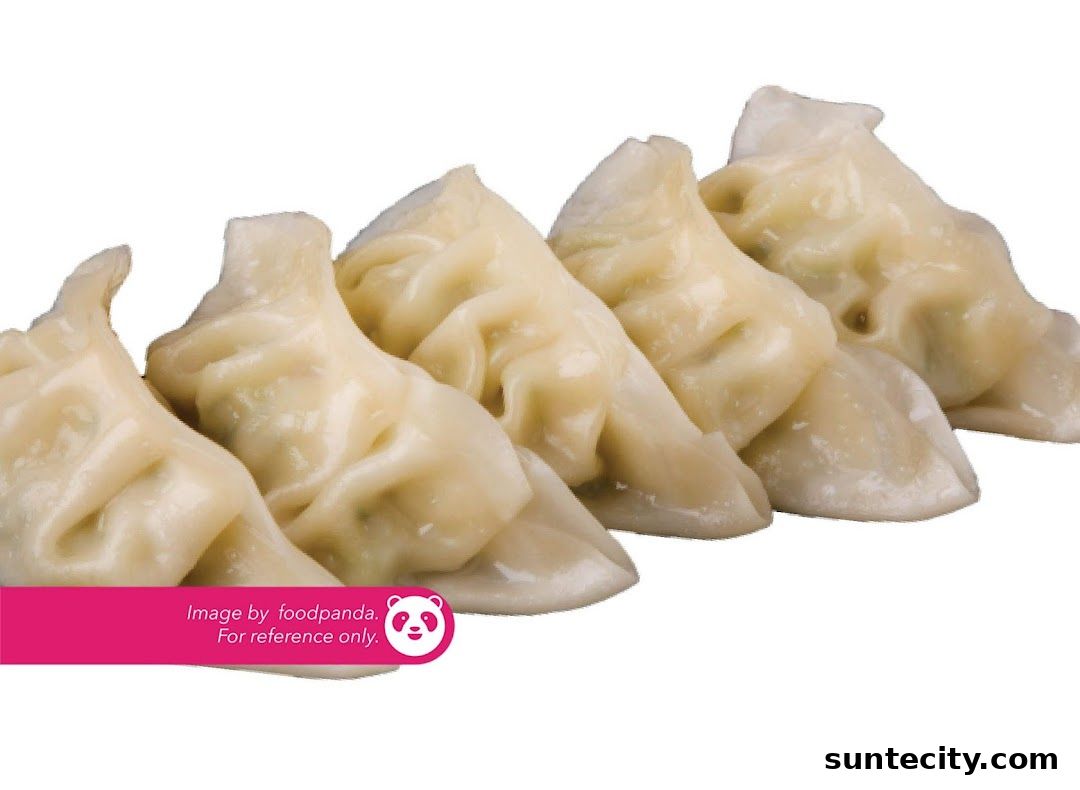A close-up shot of five steamed dumplings arranged in a row.