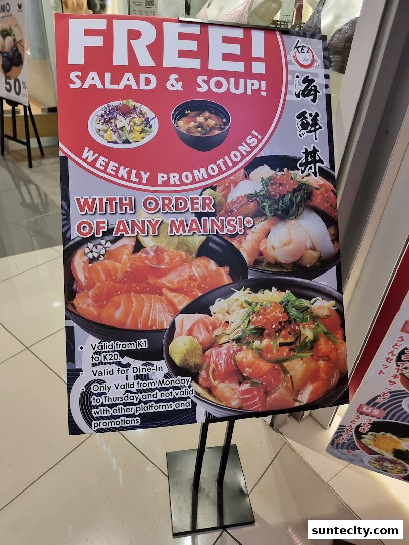 A promotional sign for Kei Kaisendon Suntec City offering free salad and soup with main orders.