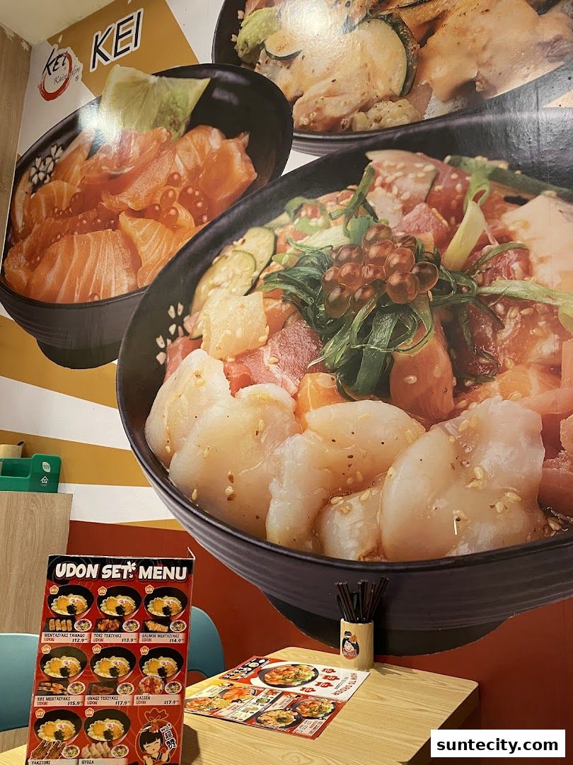 A table with a menu and a wall mural featuring various donburi dishes at Kei Kaisendon.