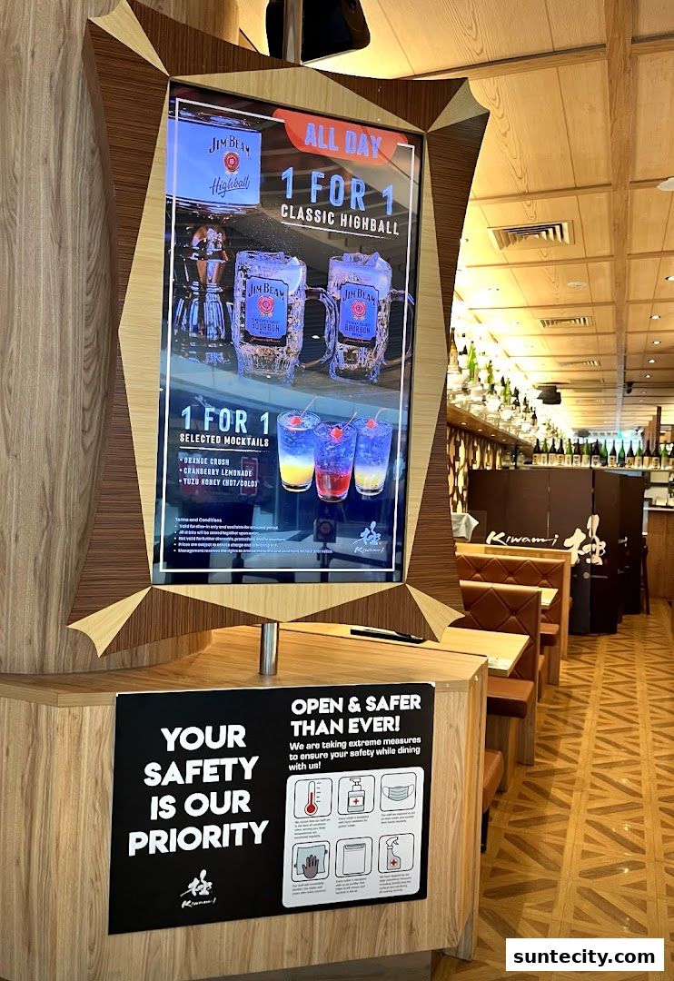 A digital display advertises 1-for-1 highballs and mocktails at Kiwami Ramen.
