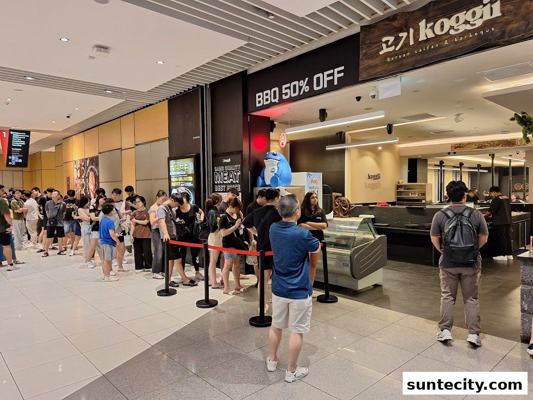 A long queue of people waiting outside Koggii, a Korean BBQ restaurant with a 50% off promotion.