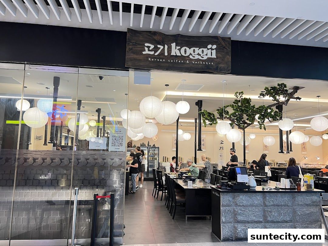 The entrance of Koggii, a Korean BBQ restaurant, with customers dining inside.
