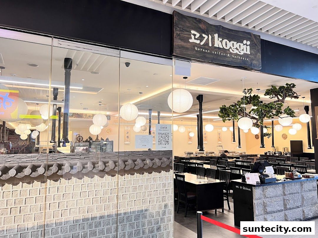 The exterior of Koggii, a Korean BBQ restaurant, with a modern interior visible through the glass.