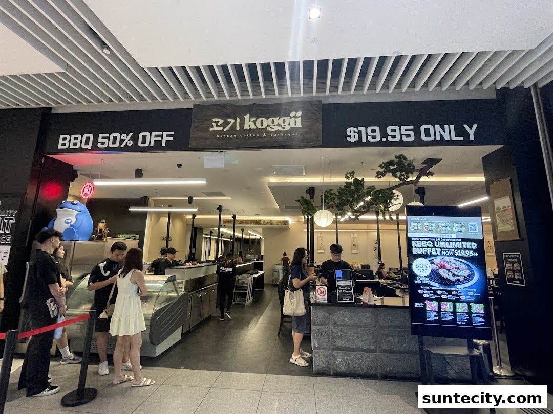 The Koggii Korean BBQ restaurant entrance with a "BBQ 50% OFF" sign and a digital menu.