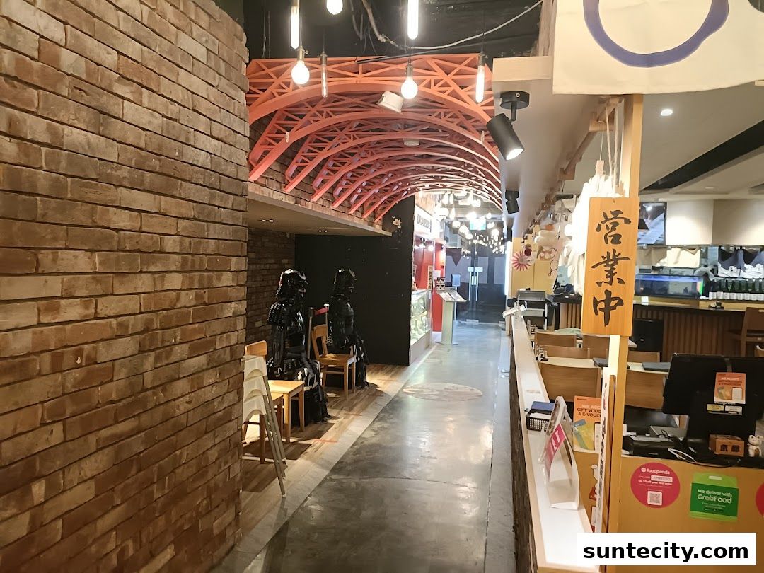 Interior view of a Japanese restaurant with samurai armor statues and a sign indicating it is open.