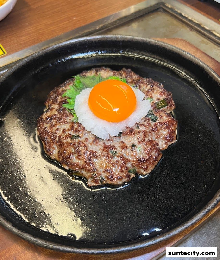 A juicy hamburger steak topped with grated daikon radish and a raw egg yolk.