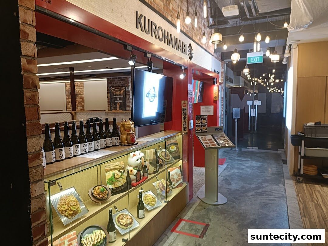 The entrance of Kurohanabi Eat at Seven, showcasing a display of food models and sake bottles.