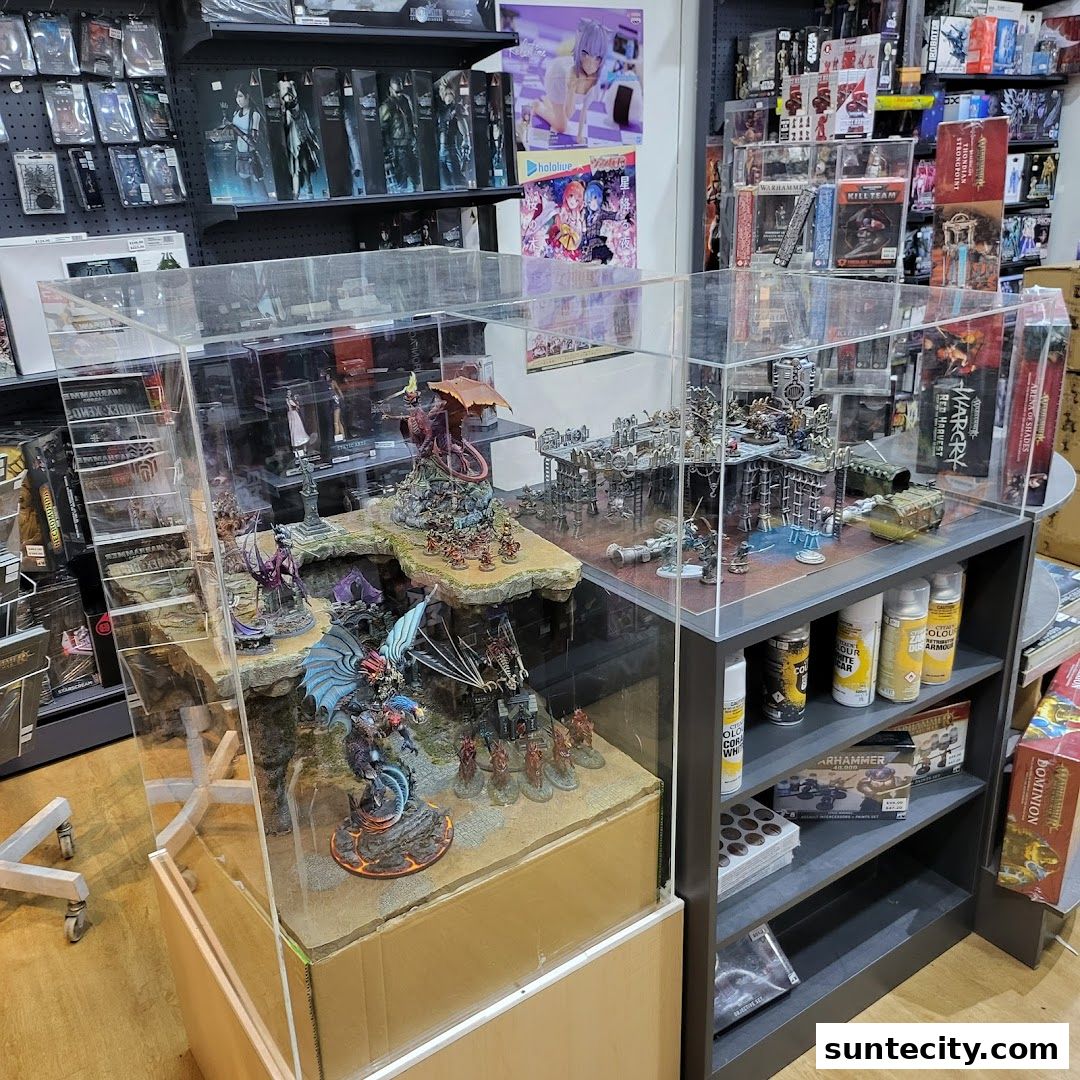 A retail shop display featuring detailed miniature dioramas and shelves stocked with hobby supplies.