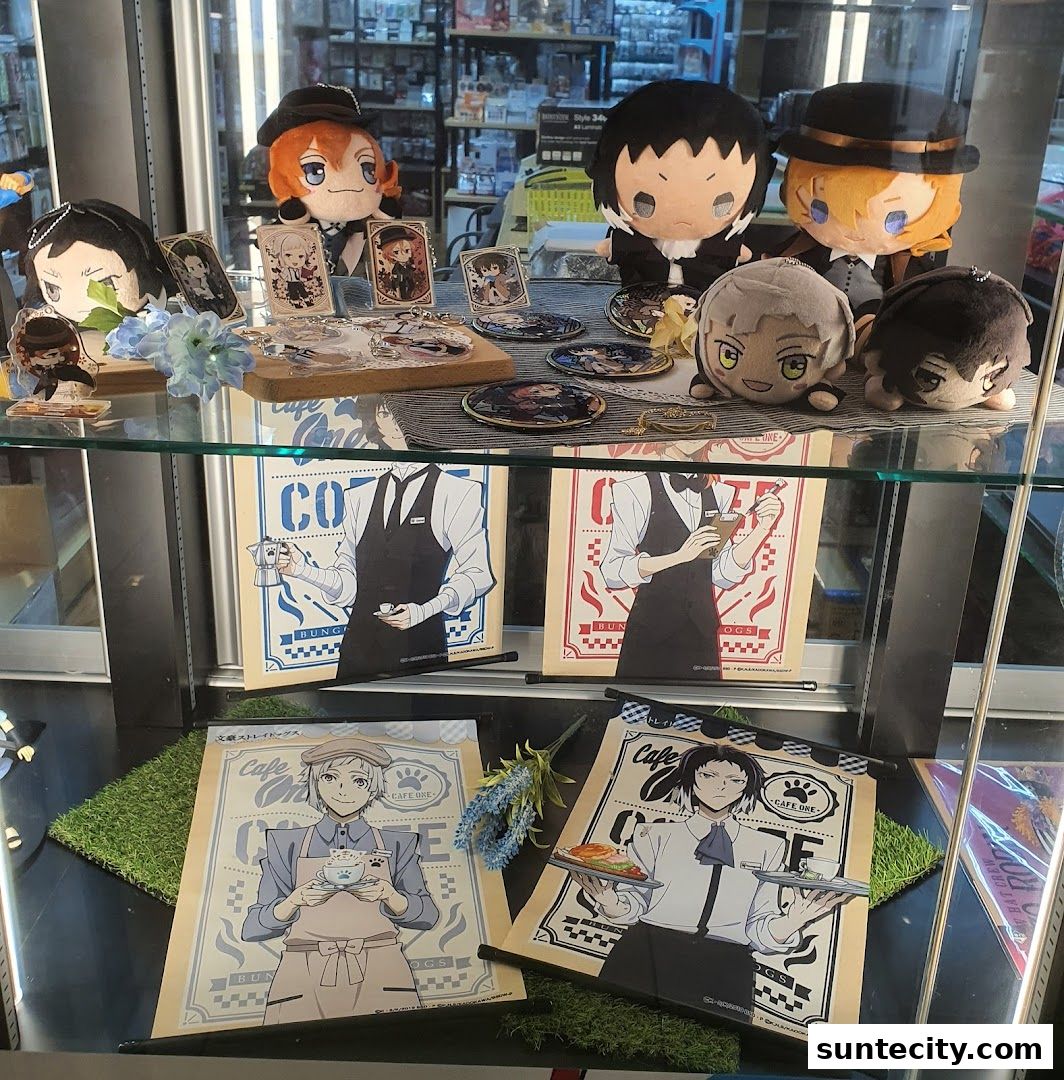A display case filled with anime merchandise, including plush toys and posters featuring cafe-themed characters.