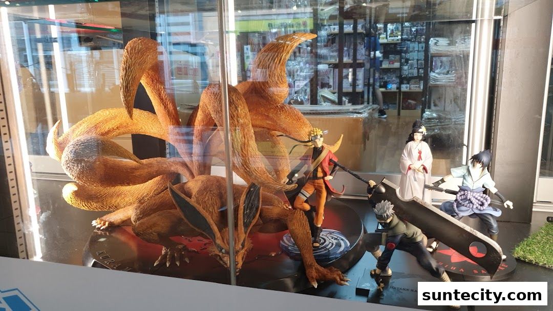 Display of Naruto anime figurines featuring Kurama, Naruto, Sasuke, Kakashi, and Hinata.