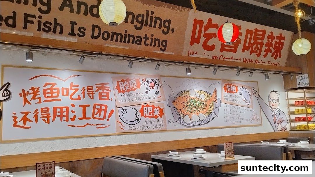 Interior of a restaurant with decorative wall art featuring grilled fish and text.