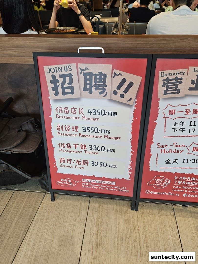 A-frame sign advertising job openings and business hours for a restaurant.