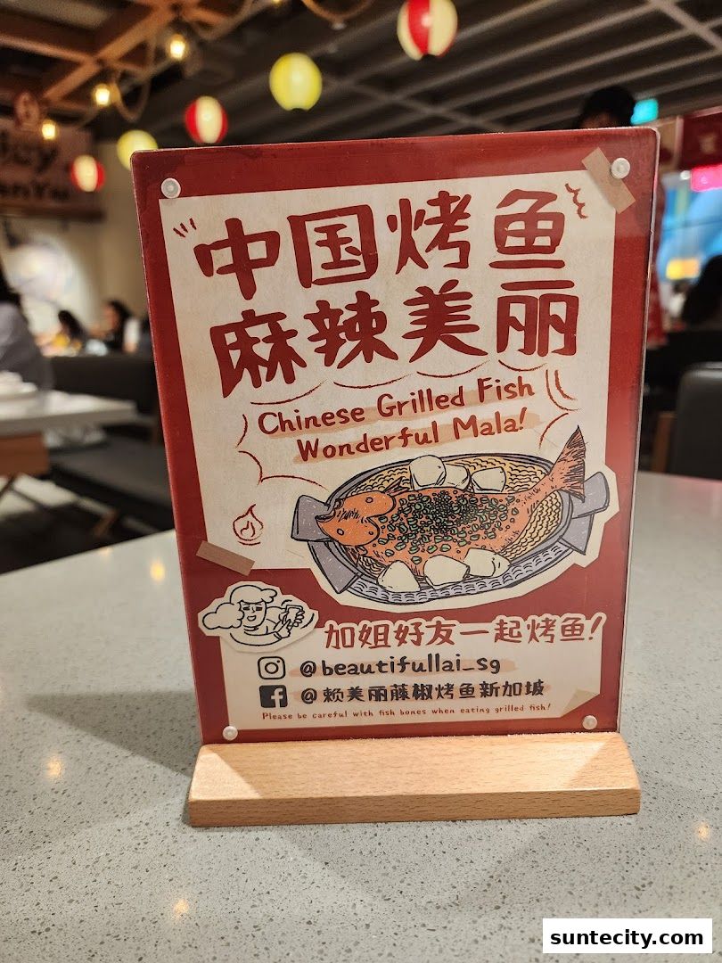 A sign for 'Beautiful Lai Grilled Fish' featuring Chinese text and an illustration of grilled fish.
