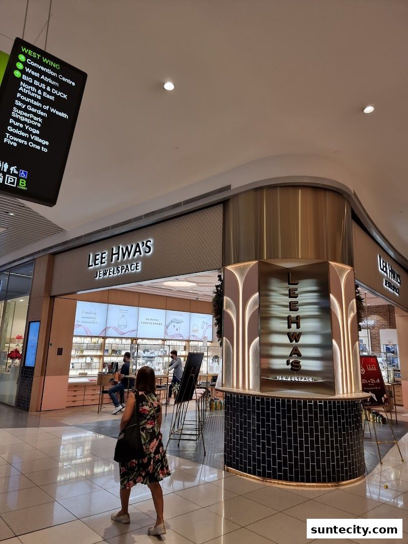 The exterior of Lee Hwa's Jewelspace store in a shopping mall, with customers browsing.