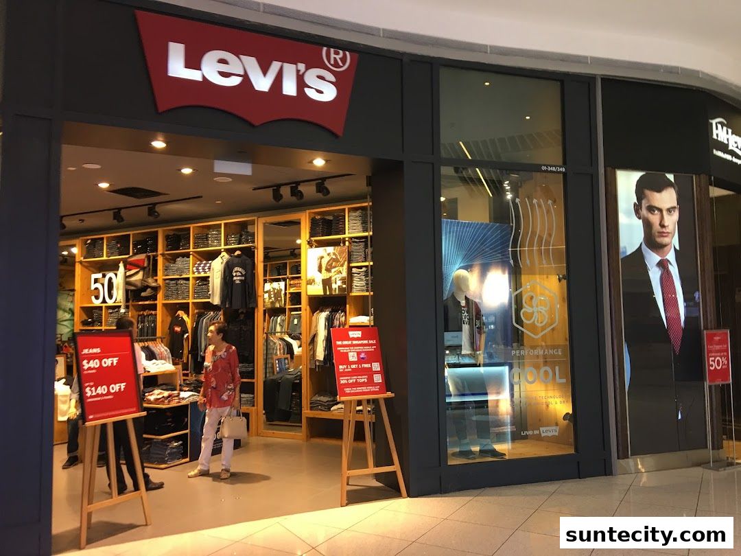 The entrance of a Levi's store showcasing jeans and apparel with promotional signs.