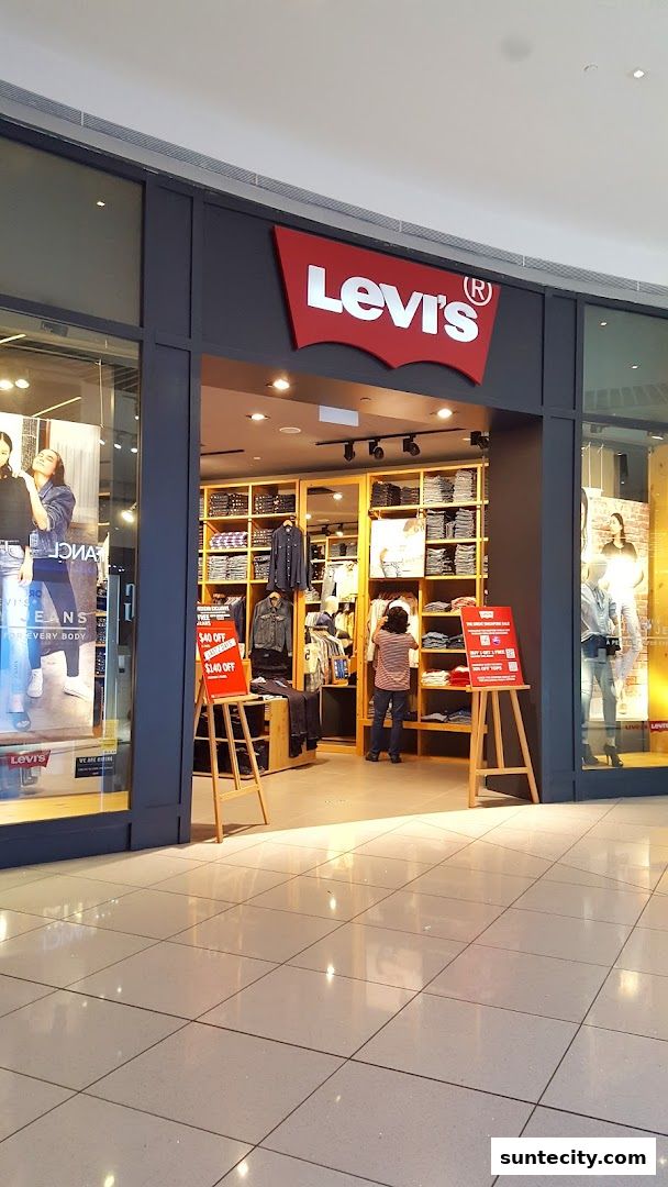 The entrance of a Levi's store with clothing displayed on shelves and mannequins.