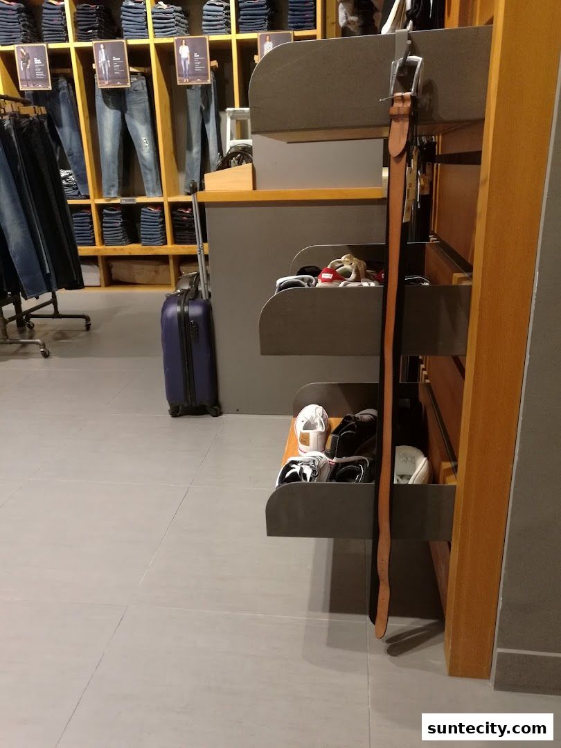 Interior view of a Levi's store showcasing denim jeans, accessories, and footwear.