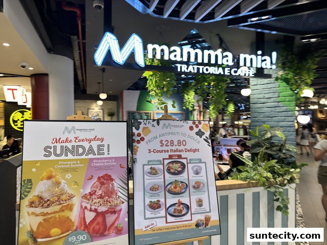 A restaurant storefront with a prominent sign and two promotional boards displaying food items.