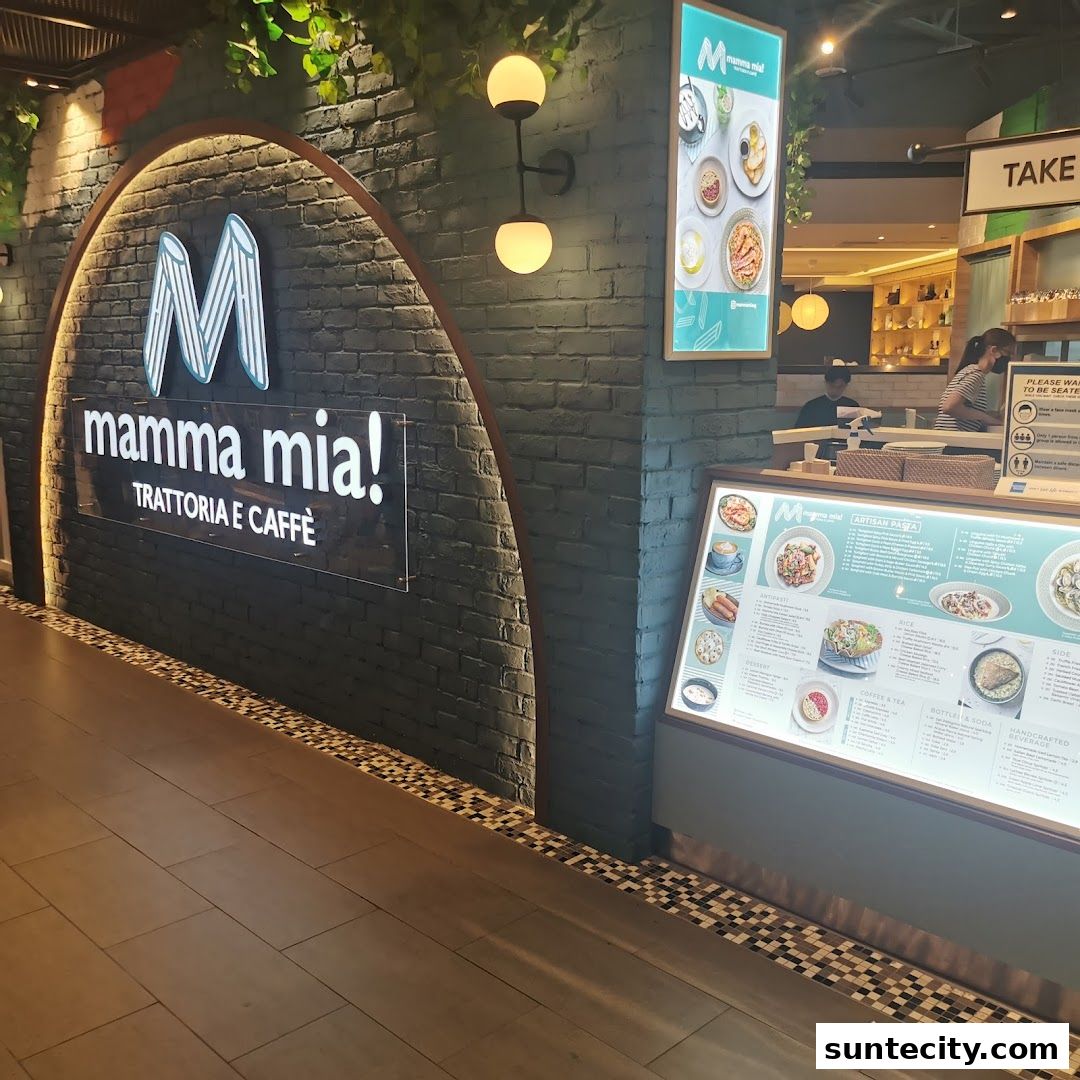 The entrance of Mamma Mia Trattoria E Caffè with its illuminated sign and a displayed menu.