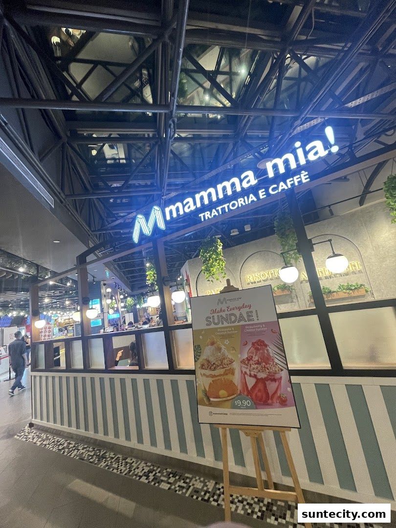 The exterior of Mamma Mia Trattoria E Caffè with a neon sign and a sundae promotion.