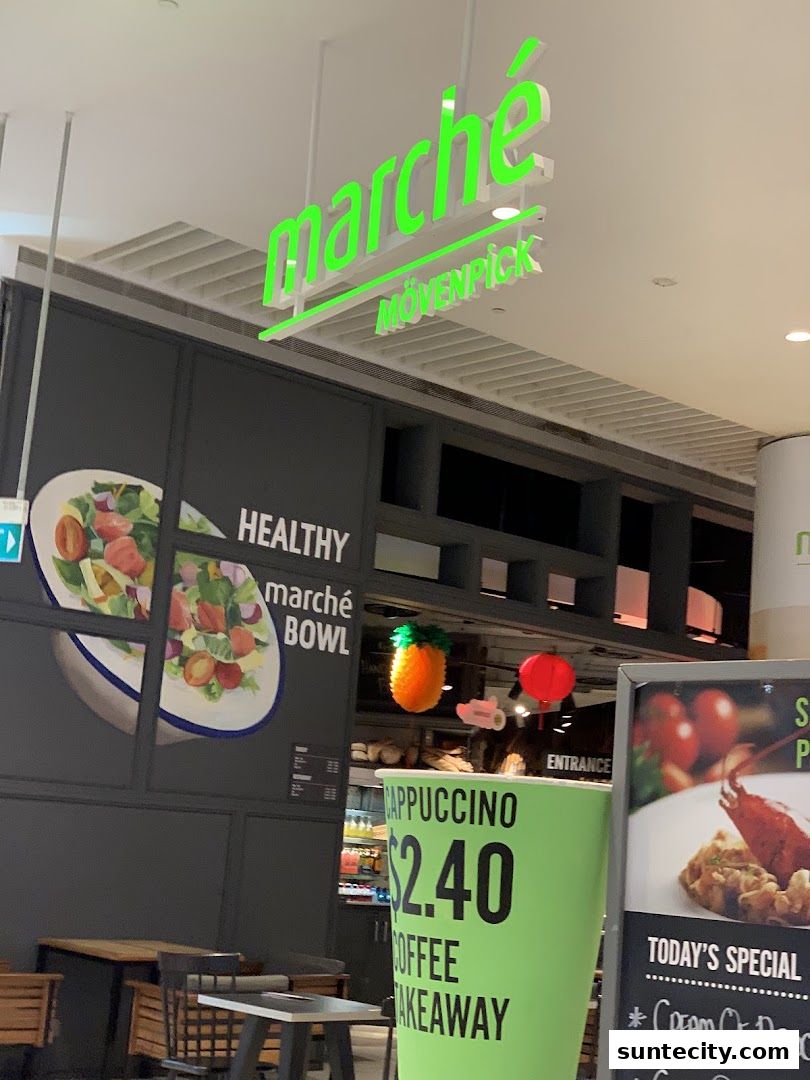 Marché Mövenpick shop front with a large green cup advertising coffee takeaway.