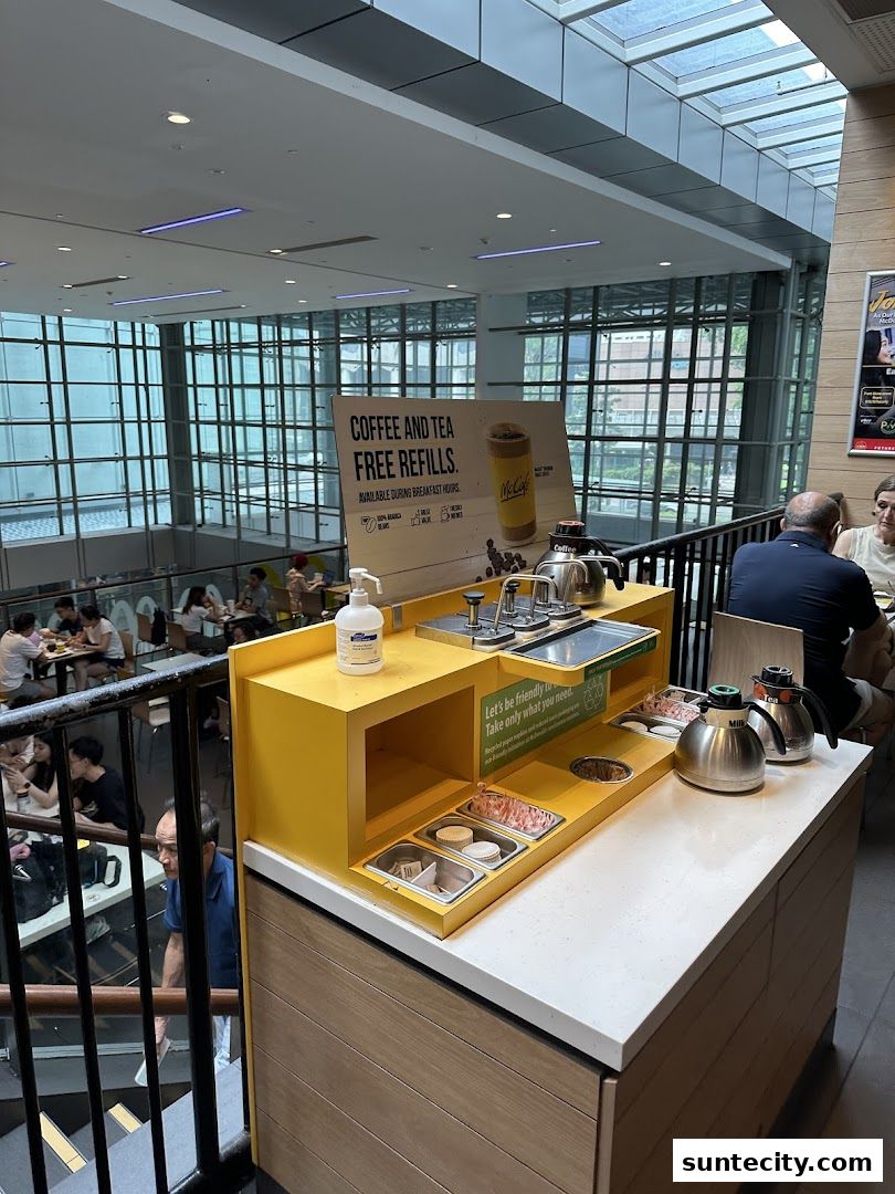 A self-serve station at McDonald's with coffee and tea free refills and condiments.