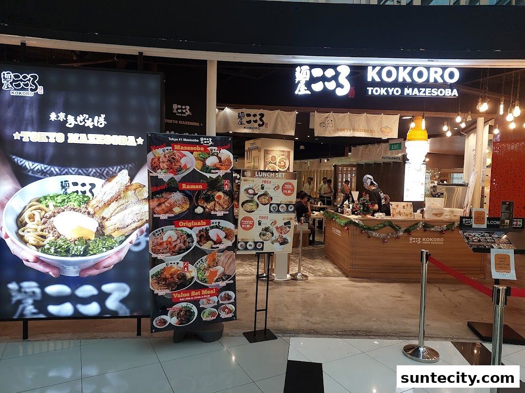 The exterior of a Kokoro Tokyo Mazesoba restaurant with a large display of their signature dish.